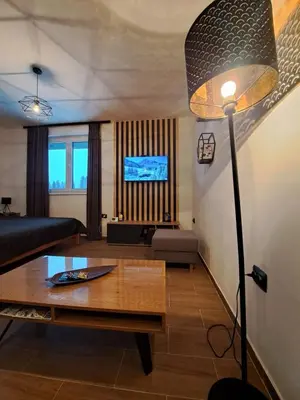 a living room with a table and a lamp at Twin mountain in Kopaonik