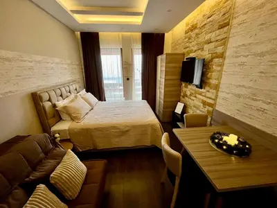 a hotel room with a bed and a couch at Apartman K3 Milmari Kopaonik in Kopaonik