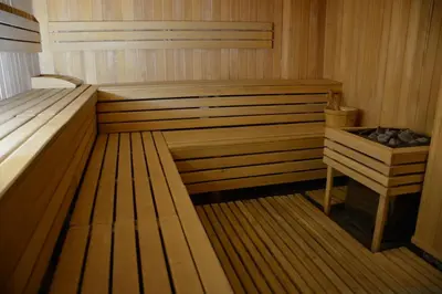 a wooden sauna with a bed and a table at Apartman K3 Milmari Kopaonik in Kopaonik