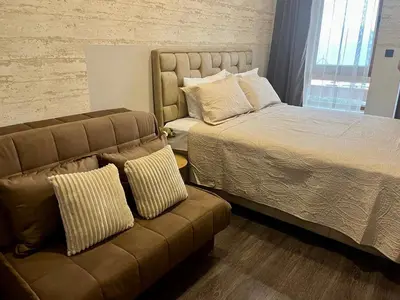 a bedroom with a bed and a couch at Apartman K3 Milmari Kopaonik in Kopaonik