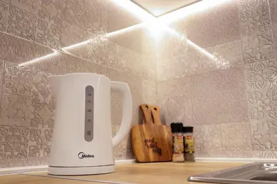 a white coffee maker sitting on a kitchen counter at Heart of Niš in Niš