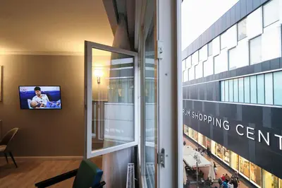 a window in a building with a tv on the wall at Heart of Niš in Niš