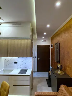 a kitchen and living room with a counter and a table at PLEASURE LUX GOLD in Kopaonik