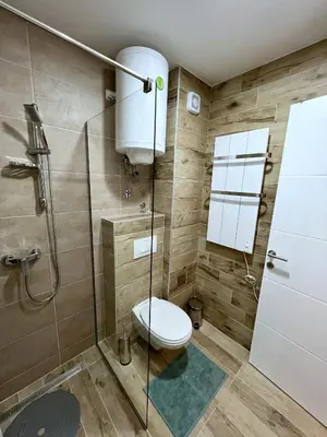 a bathroom with a toilet and a shower at PLEASURE LUX GOLD in Kopaonik