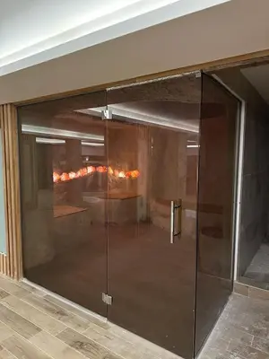 a glass door in a room with a fireplace at PLEASURE LUX GOLD in Kopaonik