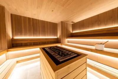 a wooden sauna with a stove in the middle at KOPAONIK WOODSIDE 58,70 m2 FREE Parking in Kopaonik
