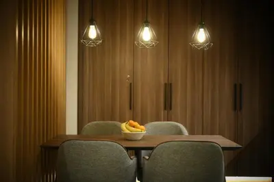 a table with chairs and a bowl of fruit on it at KOPAONIK WOODSIDE 58,70 m2 FREE Parking in Kopaonik