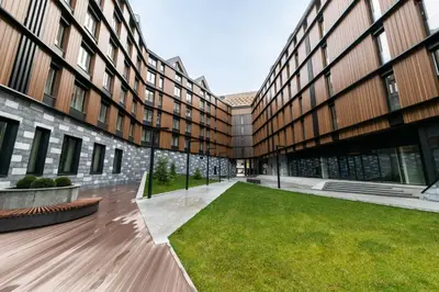 an empty courtyard of a building with a lawn at KOPAONIK WOODSIDE 58,70 m2 FREE Parking in Kopaonik