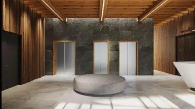 a room with a ottoman in the middle of a room at KOPAONIK WOODSIDE 58,70 m2 FREE Parking in Kopaonik