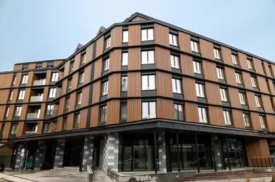 an office building with a brown building at WOODSIDE Apartment M Kopaonik FREE Parking in Kopaonik
