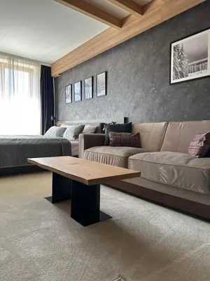 a living room with a couch and a coffee table at WOODSIDE Apartment M Kopaonik FREE Parking in Kopaonik
