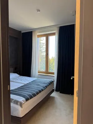 a bedroom with a bed and a large window at Woodside Apartment 431, Kopaonik - One separate bedroom 35m2- FREE Parking & SPA in Kopaonik