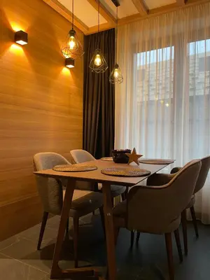 a dining room table with chairs and a star on it at Woodside Apartment 431, Kopaonik - One separate bedroom 35m2- FREE Parking & SPA in Kopaonik