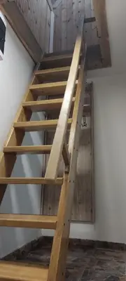 a staircase in a house with wooden beams at Sova Kopaonik in Kopaonik