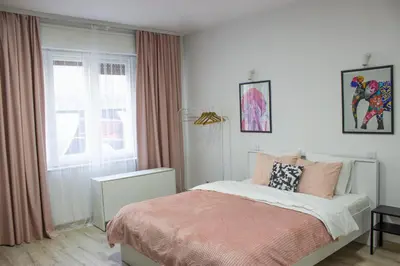 a bedroom with a bed and a window at Town Space Apartment Niš in Niš