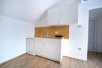 a kitchen with white cabinets and a sink at Bumerang in Soko Banja