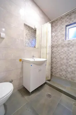 a bathroom with a white sink and a toilet at Bumerang in Soko Banja