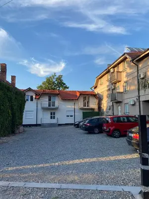 a parking lot with cars parked in front of some buildings at Bumerang in Soko Banja