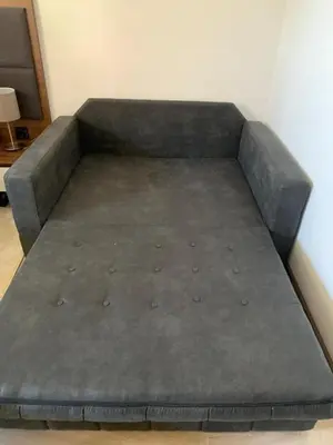 a futon bed in a room with at Kopaonik Zoned 2 in Kopaonik