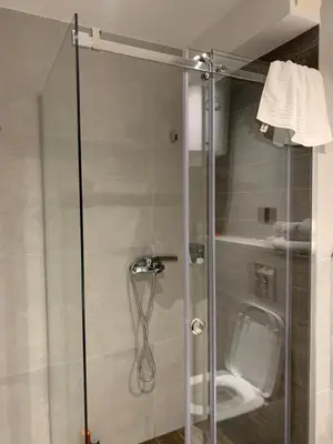 a shower with a glass door in a bathroom at Kopaonik Zoned 2 in Kopaonik