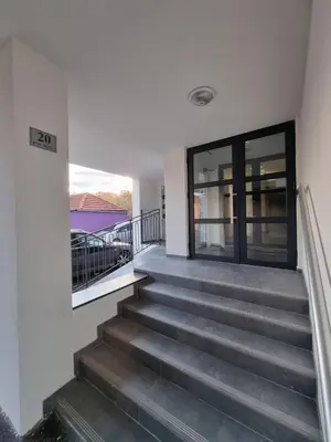 a staircase in a house with a glass door at Vlyche apartment FREE PARKING in Niš