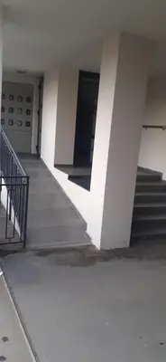 an empty hallway of a building with stairs at Vlyche apartment FREE PARKING in Niš