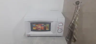 a microwave oven with food inside of it at Vlyche apartment FREE PARKING in Niš