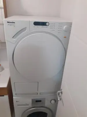 a white toilet with the lid up in a bathroom at Vlyche apartment FREE PARKING in Niš