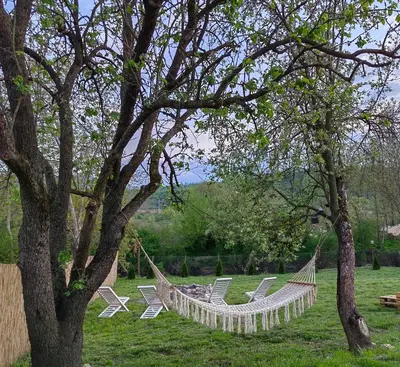a group of chairs and hammocks in a yard at Brvnara Riva in Niš