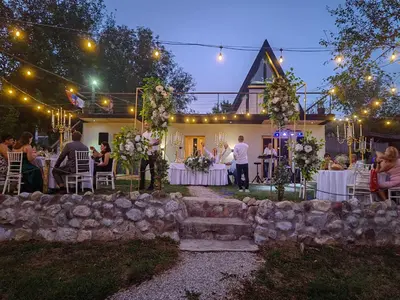 a wedding reception in the backyard of a house at night at Brvnara Riva in Niš