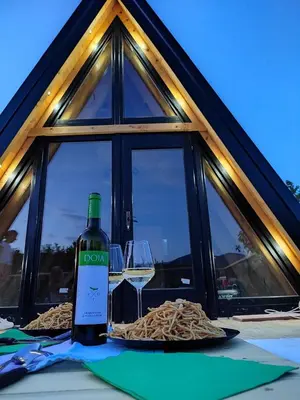 a bottle of wine sitting on a table with a glass at Brvnara Riva in Niš