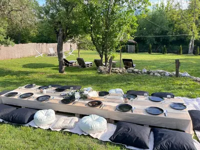 a table set up for a party in the grass at Brvnara Riva in Niš