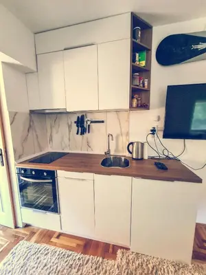 a kitchen with white cabinets and a sink at The spots - 300m from the Gondola in Brzeće