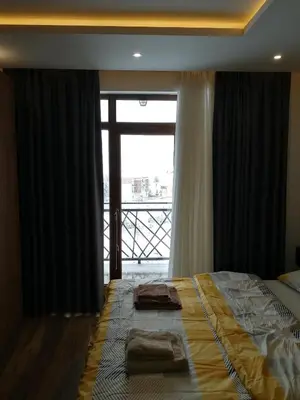 a bedroom with a bed and a large window at President Kop A-406 - Apartman Wiseman in Kopaonik