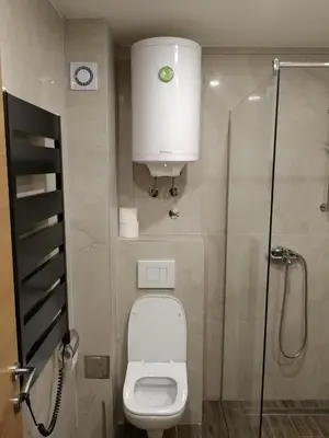 a small bathroom with a toilet and a shower at President Kop A-406 - Apartman Wiseman in Kopaonik