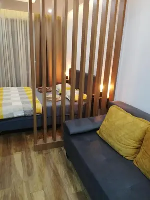 a room with two beds and a couch in it at President Kop A-406 - Apartman Wiseman in Kopaonik