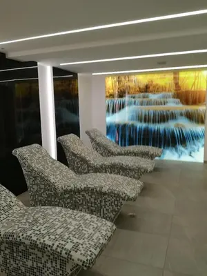 a row of chairs in a room with a painting at President Kop A-406 - Apartman Wiseman in Kopaonik
