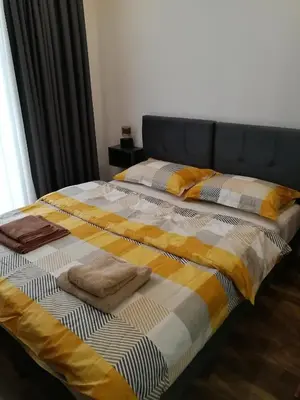 a bed with two pillows on top of it at President Kop A-406 - Apartman Wiseman in Kopaonik