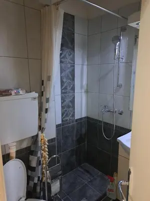a bathroom with a shower and a toilet at Apartman sa panoramom in Kruševac