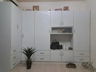 a large white cabinet in a room with a potted plant at Apartman sa panoramom in Kruševac