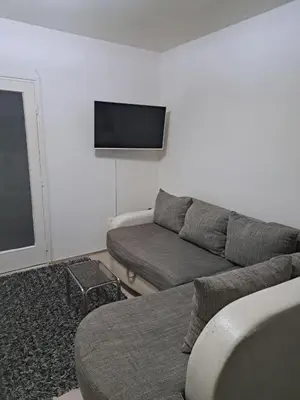 a living room with a couch and a flat screen tv at Apartman sa panoramom in Kruševac