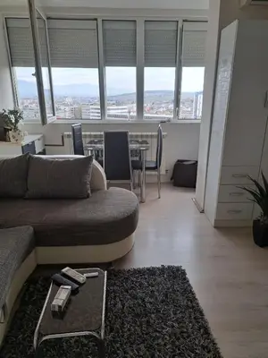 a living room with a couch and a table at Apartman sa panoramom in Kruševac