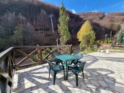 a table and chairs sitting on a patio at APARTMAN NA STAZI - Bela Reka, Kopaonik in Brzeće