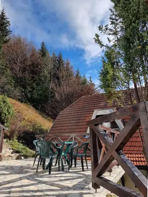 a group of green chairs sitting on a patio at APARTMAN NA STAZI - Bela Reka, Kopaonik in Brzeće