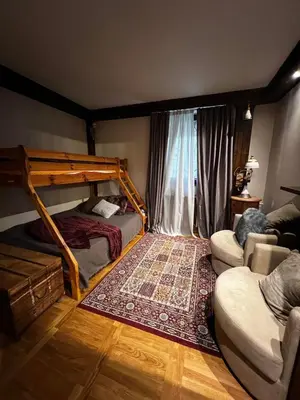 a bedroom with a bunk bed and a couch at Winter magic centar in Kopaonik