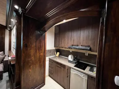 a kitchen with wooden cabinets and a stove top oven at Winter magic centar in Kopaonik