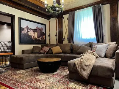 a living room with a couch and a table at Winter magic centar in Kopaonik