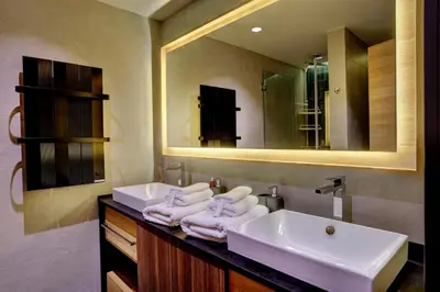 a bathroom with two sinks and a large mirror at Woodside Kopaonik 417-418 in Kopaonik