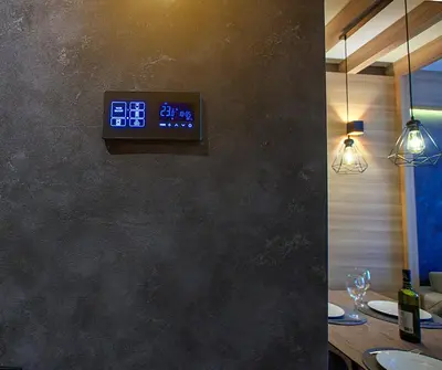 a clock on the wall of a restaurant with a table at Woodside Kopaonik 417-418 in Kopaonik