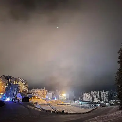a city at night with snow covered trees and buildings at Woodside Kopaonik 417-418 in Kopaonik